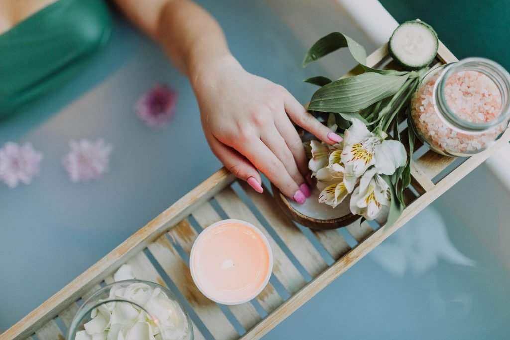 Elegant spa setting with flowers, bath salts, and calming ambiance for ultimate relaxation.